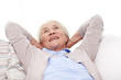 © Syda Productions - happy senior woman resting on sofa at home