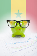 Piggy bank with flag on background - Senegal