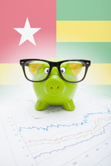 Piggy bank with flag on background - Togo