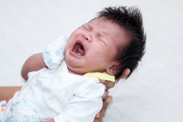 Closeup of Newborn Baby on mother hands, 13 days old.