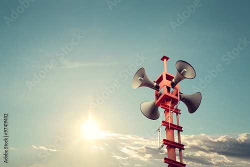 Foto Horn speaker for public relations sign symbol, vintage color - sun with blue sky