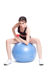 Fitness woman sport training with exercise ball and lifting weights