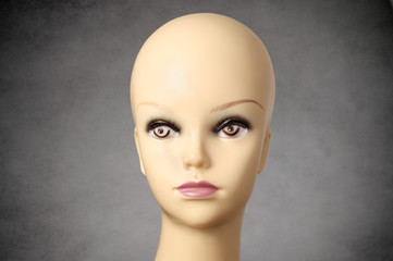 Mannequin head on dark grey background