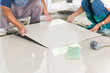 worker putting ceramist tile on the floor. Professional ceramist