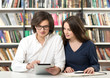 © ImageFlow - man and woman studying and working in the library