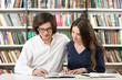 © ImageFlow - man and woman studying and working in the library