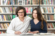© ImageFlow - man and woman studying and working in the library