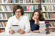 © ImageFlow - man and woman studying and working in the library