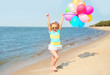 © rohappy - Happy smiling child on summer beach playing with colorful balloo