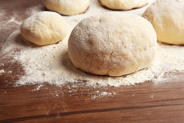 Canvas Print - Dough balls for pizza on floured wooden board