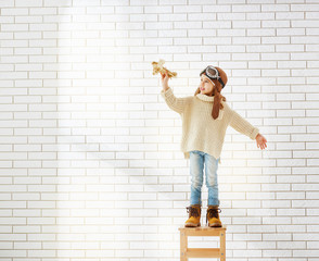 Wall Mural - girl playing with toy airplane
