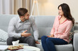 © Africa Studio - Happy couple on sofa, on home interior background