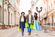 © Sergey Novikov - Three happy friends walking with shopping bags