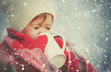 Happy Child Girl With Cup Of Hot Drink On Cold Winter Outdoors