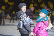 Happy Children Ice Skating At Ice Rink, Winter Night