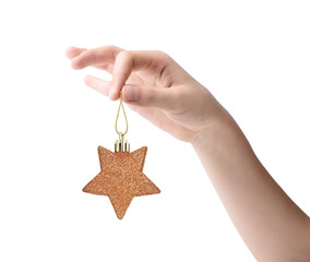 Female hand holding a Christmas toy isolated on white background