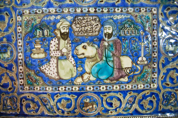 Ceramic tiles of 19th century with a lion and two persian men talking in garden