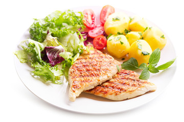 plate of grilled chicken breast with vegetables