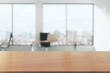 Leinwandbild Motiv Wooden table in light office with panoramic windows