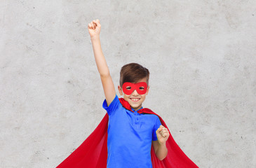 Wall Mural - boy in red superhero cape and mask showing fists