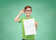 © Syda Productions - happy boy in eyeglasses holding school test result