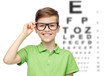 © Syda Productions - happy boy in eyeglasses over eye chart