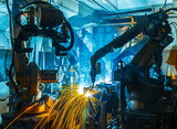 Fototapeta Tęcza - Team welding Robot movement Industrial automotive part in factory