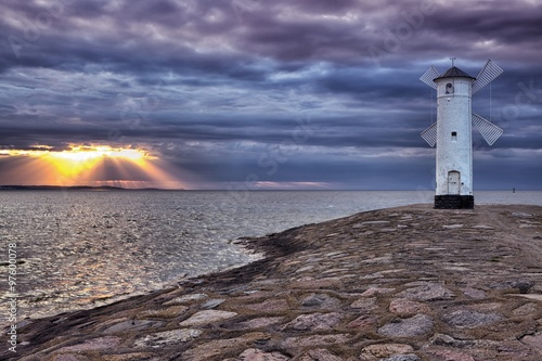 Fototapeta na wymiar Lighthouse windmill Stawa Mlyny, Swinoujscie, Baltic Sea, Poland.
