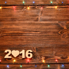 Christmas Background With Christmas Lights On The Old Wooden Planks