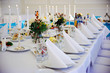 © maestrovideo - Festive table. Table setting. Festive round table with food.  Starched napkins and Cutlery. Festive meals. Restaurant inside. Service holidays. Вesign of the hall.