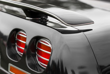 Close-up Of Red Tail Lights Of A Black Shiny Classic Vintage Car