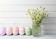 Bouquet Of Chamomiles In A Glass Vase And Easter Eggs In Pastel