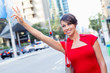 © Sergey Nivens - Businesswoman trying to catch a taxi