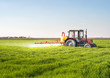 © Dusan Kostic - Tractor spraying wheat field