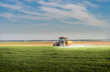© Dusan Kostic - Tractor spraying wheat field