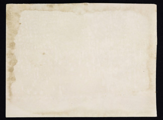 Old grunge paper sheet, isolated on black background.