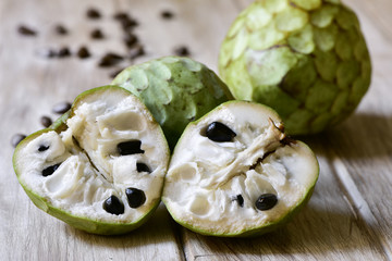 Poster - custard apples on a wooden surface