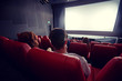 happy couple watching movie in theater or cinema