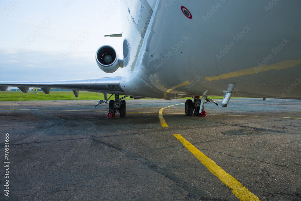 shiny fuselage jet passenger plane against the bright blue sky - obrazy, fototapety, plakaty 