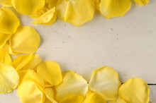 Frame Of Yellow Rose Petals On A Wood Background.