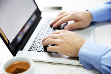 Wall Mural - Young businessman using his laptop, close up