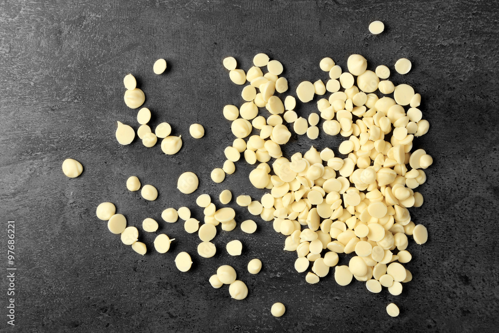 White chocolate morsels on gray background