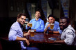 © Africa Studio - Young men drinking beer and talking in cafe