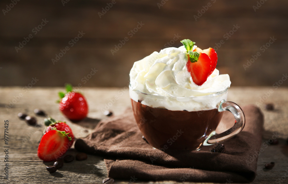 Hot chocolate with whipped cream in mug  on wooden background