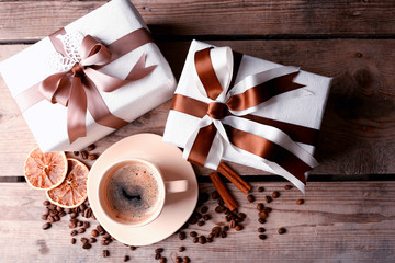 Poster - Beautiful gift, cup with coffee and coffee grains on wooden background