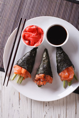 Wall Mural - Japanese food: Salmon temaki closeup. vertical top view
