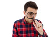© nickshot - Surprised Young man student holding magnifying glass looking to something isolated over white background.