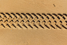 Tire Tracks On A Beach