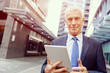 © Sergey Nivens - Senior businessman holding touchpad