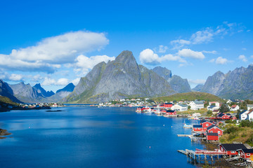 Beautiful super wide-angle summer aerial view of Reine, Norway, Lofoten Islands, with skyline, mountains, famous fishing village with red fishing cabins, Moskenesoya, Nordland